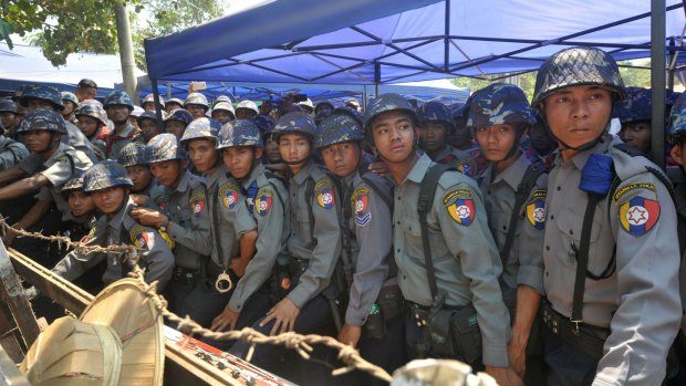 Myanmar riot police keep watch during a student protest march in Letpadan, about 130 kilometres north of Yangon. 