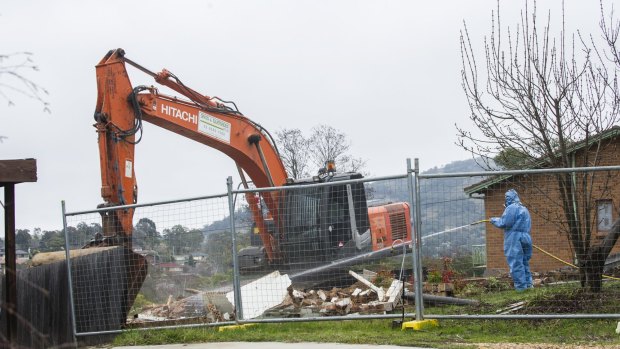 Workers demolish a Mr Fluffy home in Farrer.