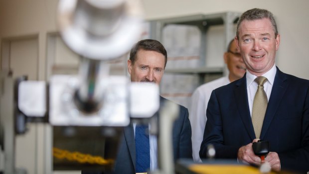 Minister for Defence Industry Christopher Pyne takes the controls while touring a new Electro Optic Systems (EOS) facility.