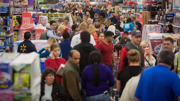 Customer flooding a Walmart store in Rogers, Arkansas, during last year's Black Friday sales. 