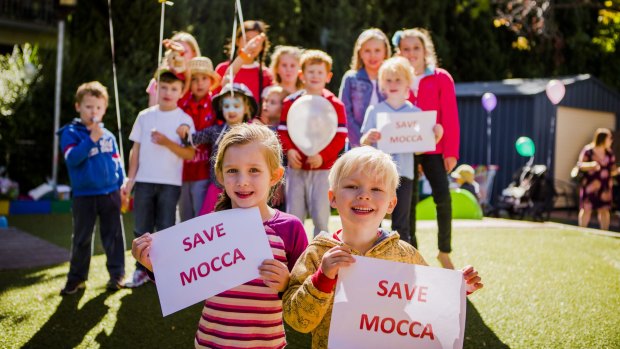 Hannah Claudianos, five, and Jack Rochester, three, join their fellow students to protest the closure of MOCCA.