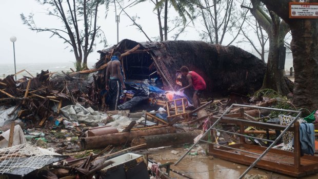 Residents looking through storm damage caused by Cyclone Pam in Port Vila
