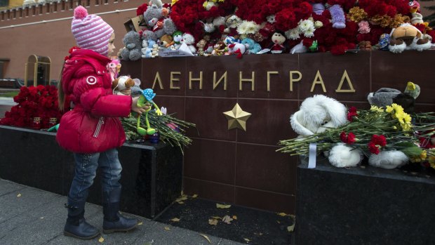 A young mourner at the Tomb of the Unknown Soldier in Moscow, which has been used as a memorial for the victims of the Metrojet crash.