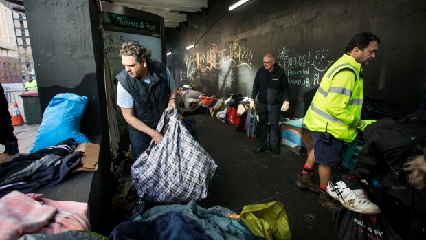 Nigel Blakemore, who had been living in Martin Place, cleans up belongings after the City of Sydney removed the homeless camp.