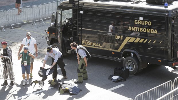 Members of Brazilian bomb squad pack their gear after detonating a suspicious package near the men's cycling road race final in Copacabana.
