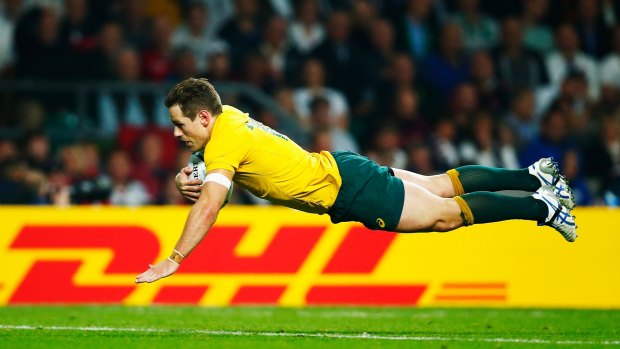 Striking a blow: Bernard Foley goes over to score Australia's second try.