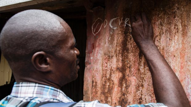 Workers conduct a door-to-door cholera vaccination.