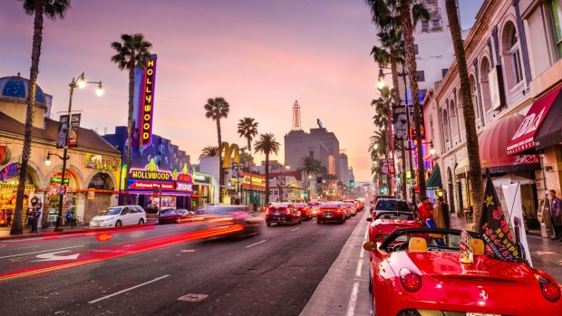 Hollywood Boulevard at dusk. The theatre district serves as a famous tourist attraction. 
