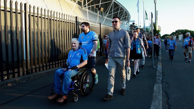 Sydney football fans arrive at Allianz Stadium, where security measures are said to have been ramped up in the wake of the Paris attacks.