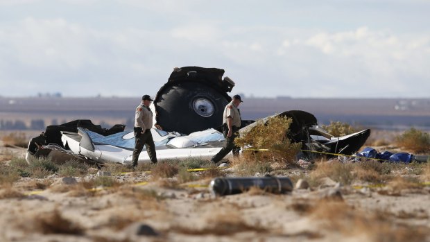Mid-air breakup: Sheriff's deputies look at  pieces of debris near the crash site of Virgin Galactic's SpaceShipTwo near Cantil, California. 