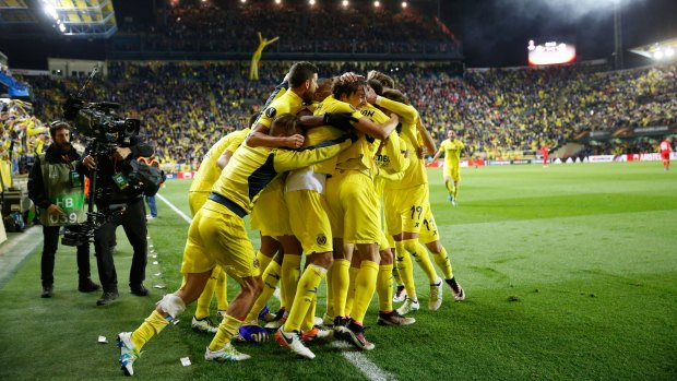 Villarreal players celebrate after scoring a goal during  their Europa League semi-final against Liverpool.