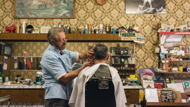 Barber Angelo Perri keeps busy at Paris Style Hairdresser, which looks like a perfectly preserved time capsule from the mid-1960s, in Cabramatta.