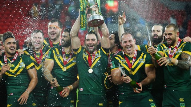Cameron Smith lifts the trophy with team mates after victory in the Four Nations Final.