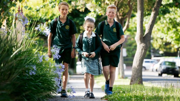 Henry, 11, Annabel, 8, and Tom Feeney, 10, walk to school by themselves.