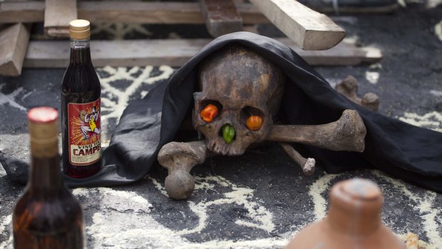 A human skull and bones are placed on the ground in a voodoo ceremony before the start of a protest to demand the president's resignation on Saturday.