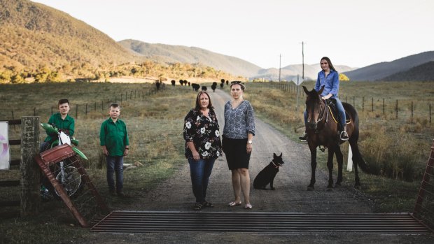 Mandy Curtis (left) and Natalie Hogan (right), neighbours of Caloola Farm, with Natalie's sons Isaac, 11, and Lewis, 8, and Mandy's daughter, Tori. 
