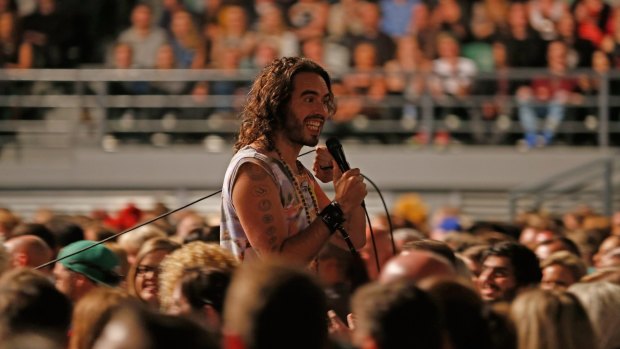 British comedian, writer and activist Russell Brand chats with the audience during his Melbourne show at Rod Laver Arena during his Trew World Order. 