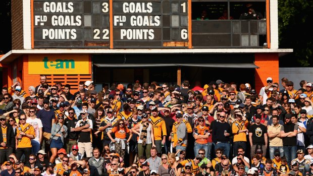 Days are numbered: Wests Tigers fans watch the action against Canberra from under the Leichhardt Oval scoreboard.