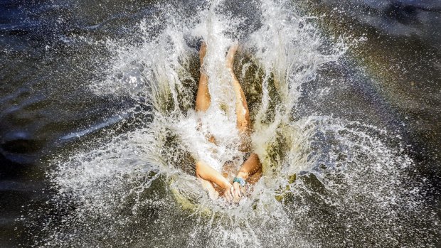 Issac, 17, cools off at Parramatta Lake on Saturday.