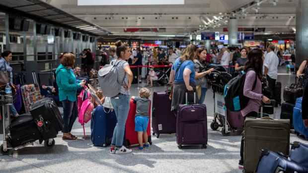 Passengers wait in the check-in counters at Istanbul's Ataturk airport following the terror attacks which killed at least 41. 