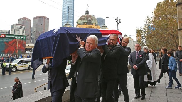 Lou Richards' coffin is carried from St Paul's Cathedral after the football great's state funeral. 