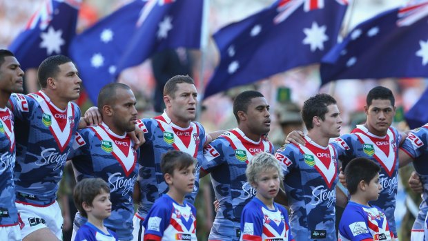 Silence, please: Roosters players line up for the Australian national anthem on Anzac Day in 2013.