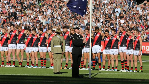 Lest we forget: Essendon players line up for the national anthem at the MCG last year.