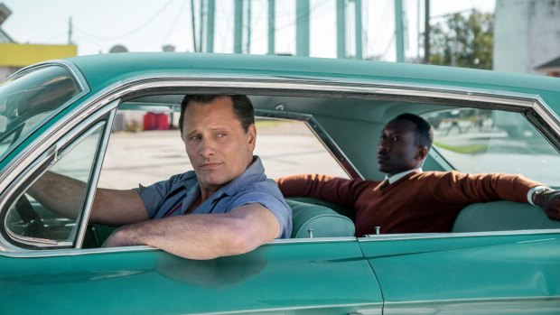 In Green Book, Tony Lip (Viggo Mortensen), left, drives Dr Don Shirley (Mahershala Ali), a renowned pianist, on a tour of the south in 1962.