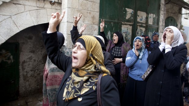 Palestinian women shout as they wait for permission to enter the Temple Mount.