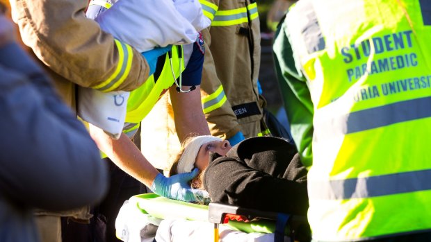 Passengers of the tram are treated by paramedics.