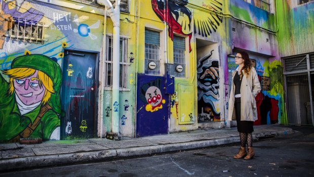Impact Comics employee Jaisun admires the street art in Tocumwal Lane. The new agenda proposes  making Civic's laneways safer, and sites for art and music.
