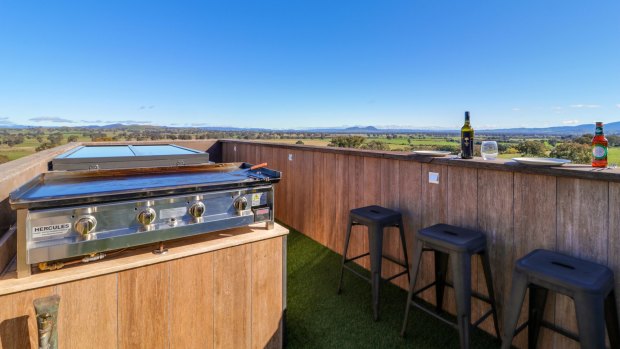 Follow the checker plate steel staircase to the rooftop terrace and you'll find a barbecue, dining area and seating. 