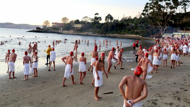 Hundreds pike it while hardy get naked for icy dip in Hobart's Derwent to  mark winter solstice