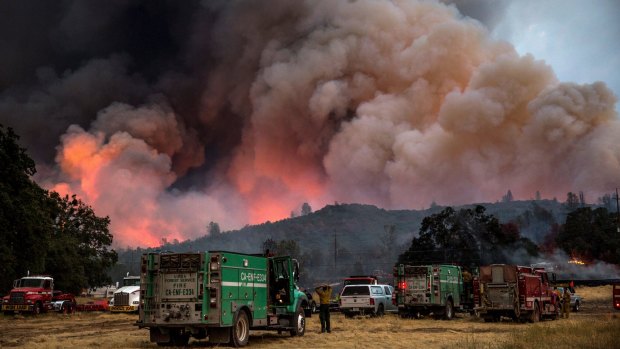 Firefighters watch the Rocky Fire advance in Lake County, California.