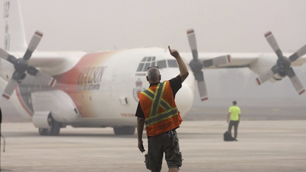 A C-130 cargo plane from NSW Rural Fire Service prepares for a water bombing mission in Palembang, South Sumatra, earlier this month.