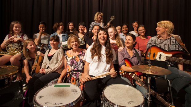Drummer Bree van Reyk, pictured in white T-shirt in the middle, is assembling a massive girl rock band featuring young local female musicians. 