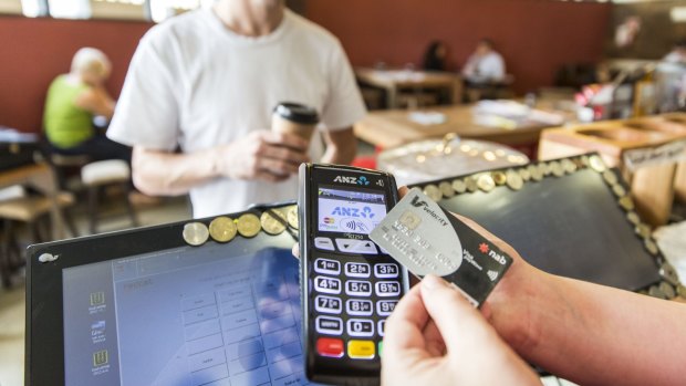 The tap and go boom has created a significant rise in some retailers' debit card costs.