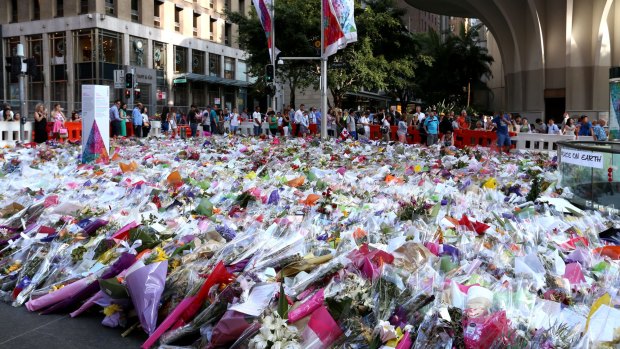 People line up to leave their flowers at Martin Place. 