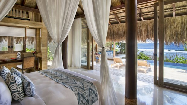 A bedroom with a pool view at the Nihiwatu resort.