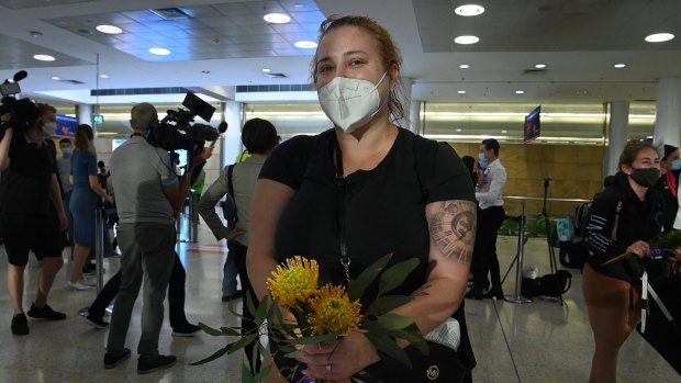 Emma Arzoumanian was among passengers given posies of Australian native flowers and gum leaves as they arrived at Sydney International Airport on Monday morning.