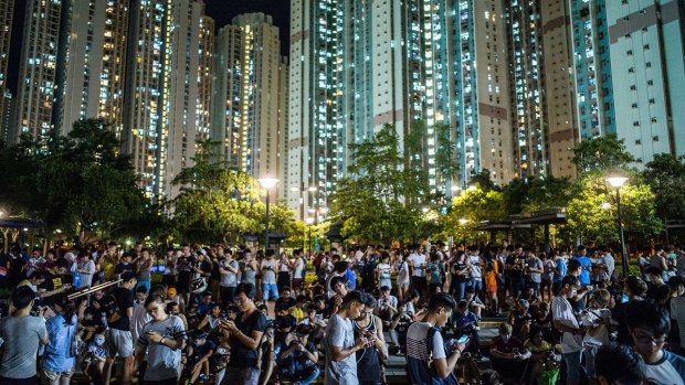 People play the Pokemon Go game at a park at Tin Shui Wai in Hong Kong. 