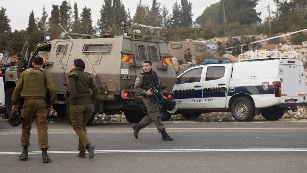 Israeli soldiers stand guard at the Halhul junction, north of the West Bank city of Hebron on Wednesday. 