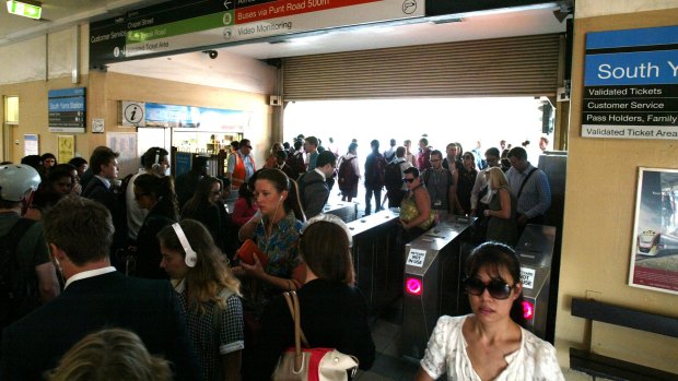Crowds at South Yarra train station filing through the gates during morning peak hour.