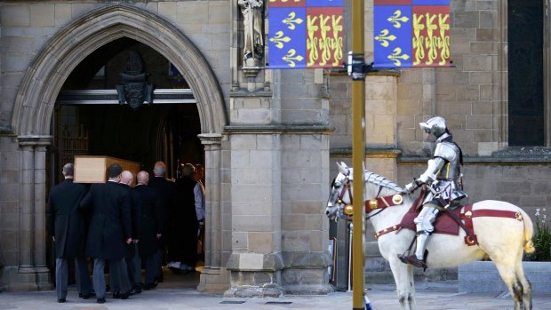 The coffin containing the remains of Richard III is carried into Leicester Cathedral.