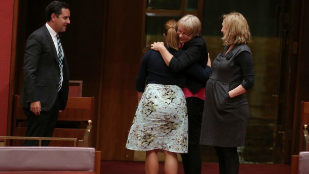 Greens senators Sarah Hanson-Young, Janet Rice and Larissa Waters embrace after the vote.