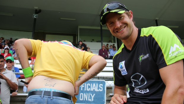 Big fan: Shane Watson autographed a devoted fan's back at Sydney Thunder Twenty20 practice game in Albury.