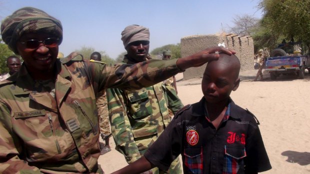 A Chadian soldier embraces a former child soldier of insurgent group Boko Haram in Ngouboua, Chad in April.