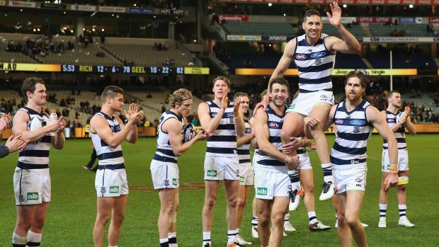 Carried away: teammates honour Harry Taylor after his 200th game for Geelong.
