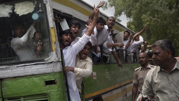 Activists of India's Congress party's youth wing shout slogans from a bus as they are detained during a protest against Shivraj Singh Chauhan, chief minister of the central Indian state of Madhya Pradesh.