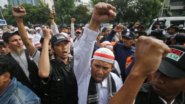 Hardline Muslims shout slogans during a rally outside the court where Jakarta governor Ahok is on trial.